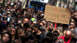 People march down Las Ramblas the day after a van crashed into pedestrians in Barcelona