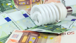 saving money saving bulb.light bulb on money euro background