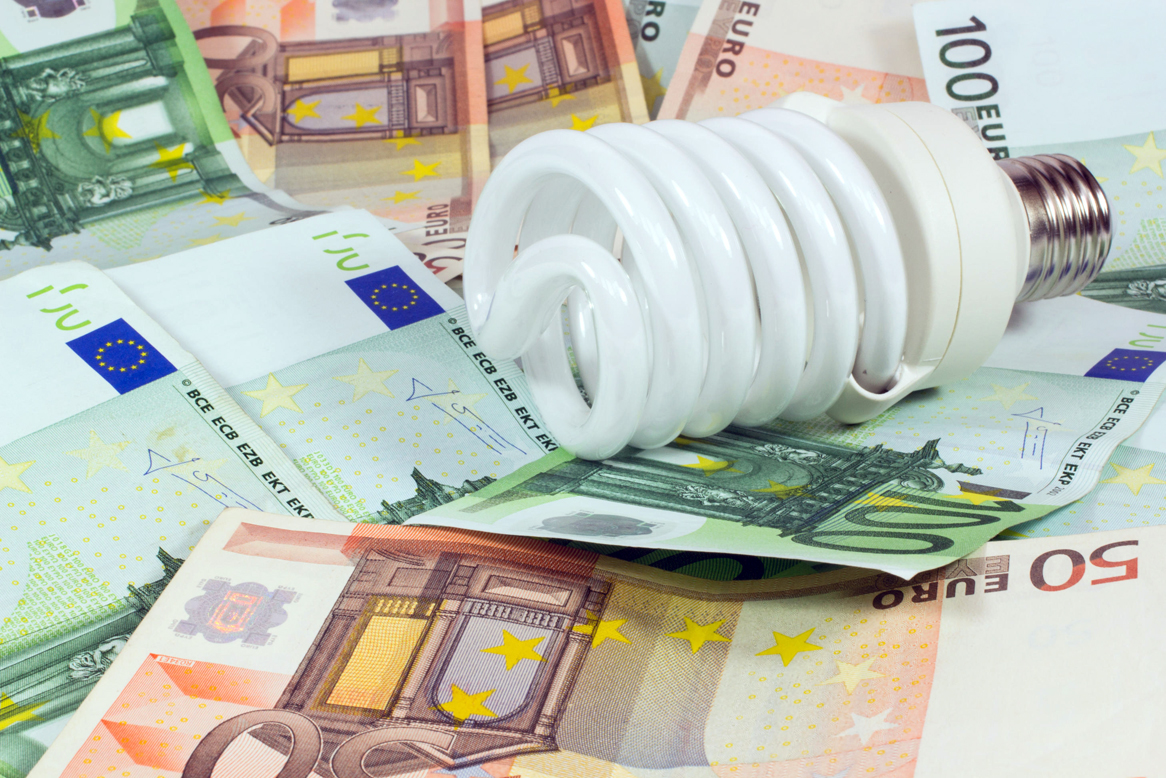 saving money saving bulb.light bulb on money euro background