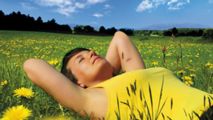 girl lying in a meadow enjoying the sun