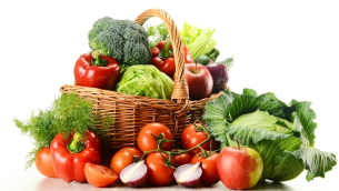 Vegetables in wicker basket isolated on white